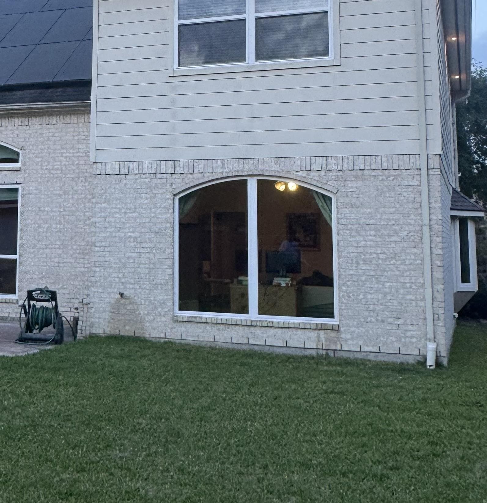 White double-hung window with Colonial grids above an arch-top picture window