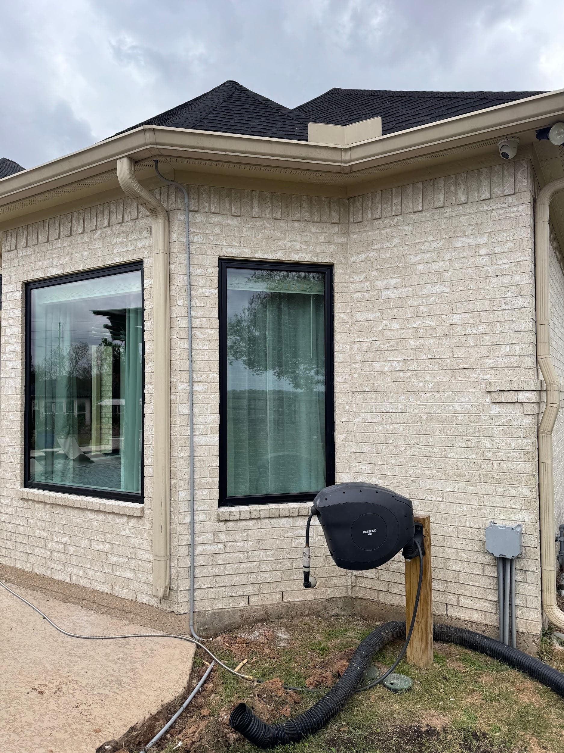 Black-framed picture and single windows on a cream stone corner
